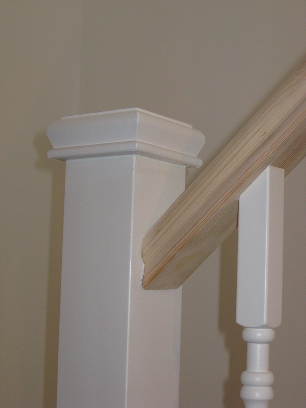 A softwood staircase for a loft conversion, painted white with feature pine handrail.