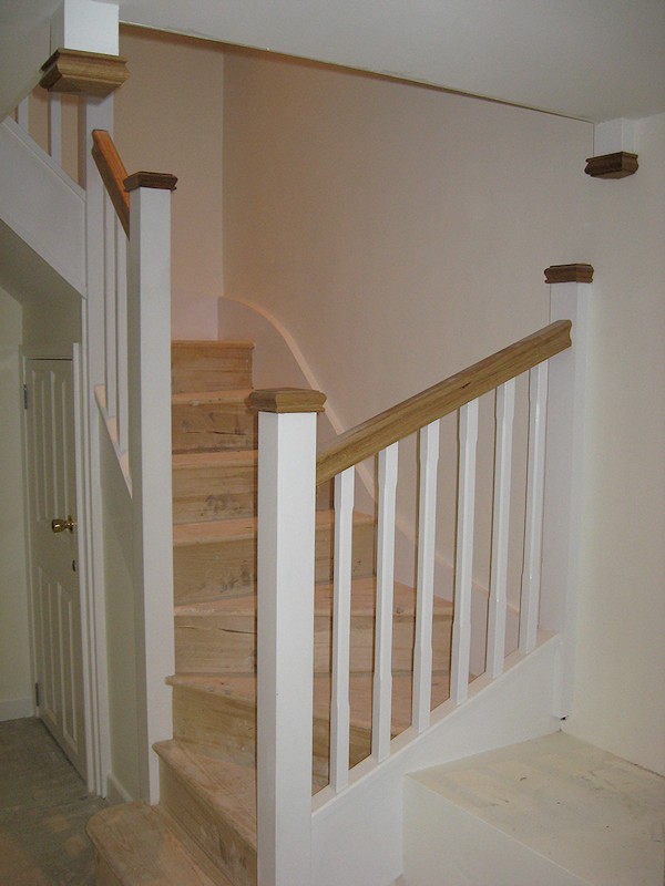 A double turn six winder staircase leading down into a basement.