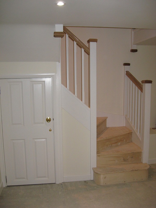 A double turn six winder staircase leading down into a basement.