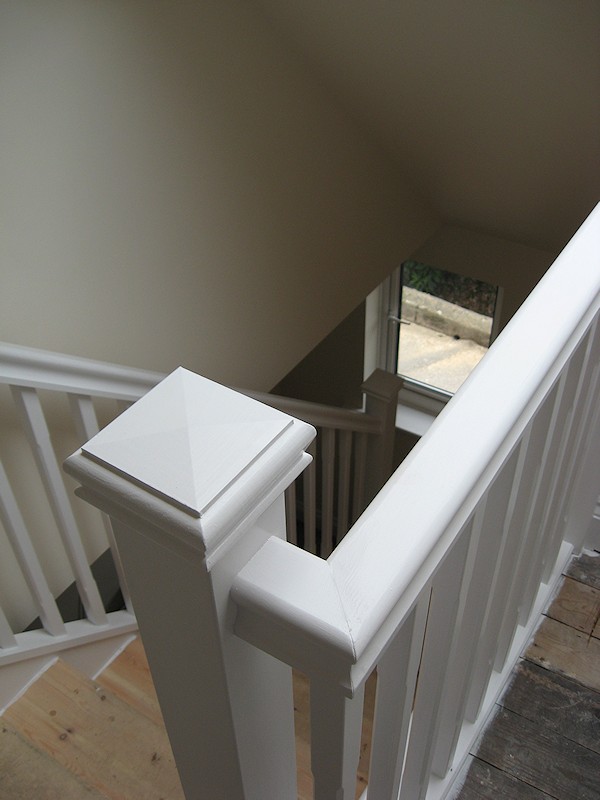 A single turn softwood three winder staircase with a bullnose bottom tread.