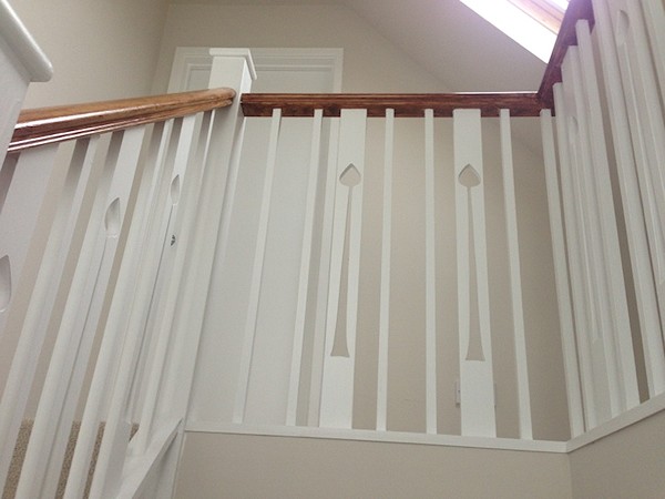 A clockwise softwood staircase with six winders around a central double newel post.