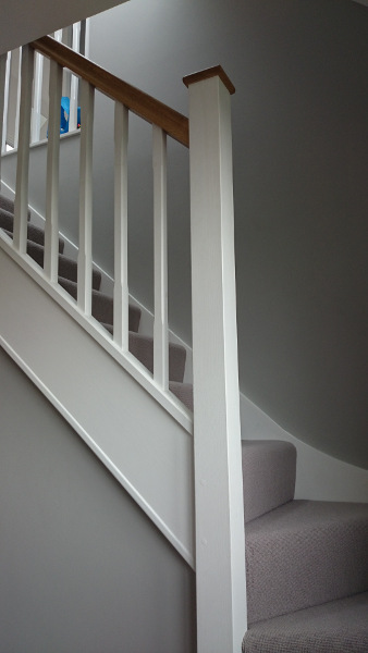 Staircase painted white with our std profile handrail and flat newel caps in oak giving a great contrasting feature.