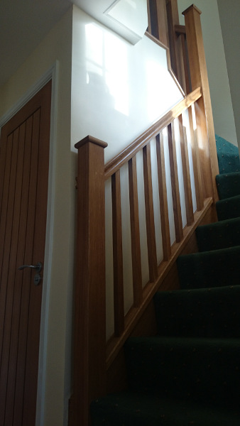 Oak construction staircase including our std handrail, square spindles and flat newel caps.