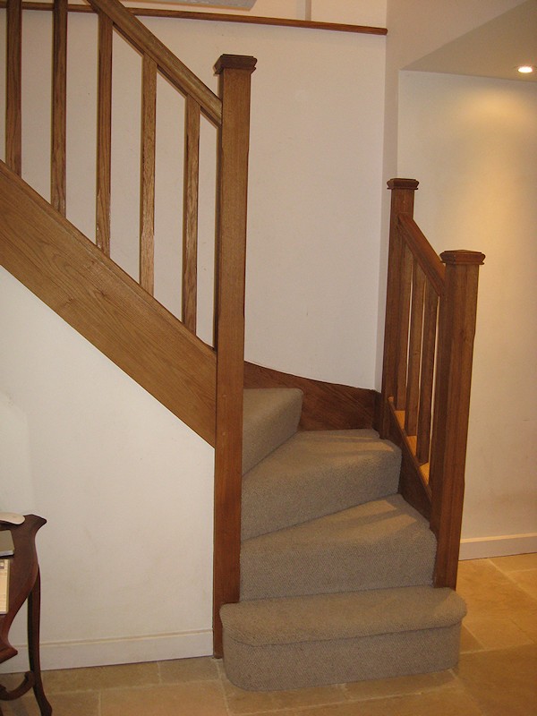 An oak double winder staircase for a farmhouse refurbishment.