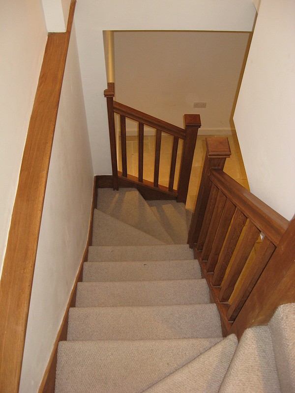 An oak double winder staircase for a farmhouse refurbishment.